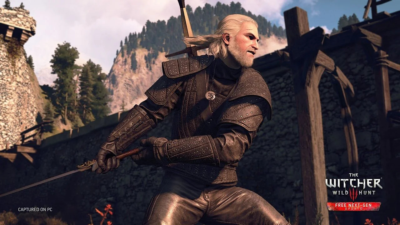Geralt of Rivia in Studded Armor with Sword Drawn Standing by a Stone Fortress with Trees and Mountains in the Background